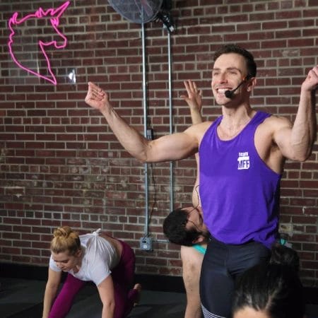 People working out with smiling coach